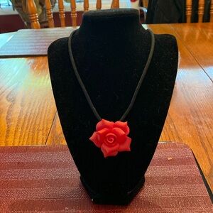 Red rose choker on velvet rope